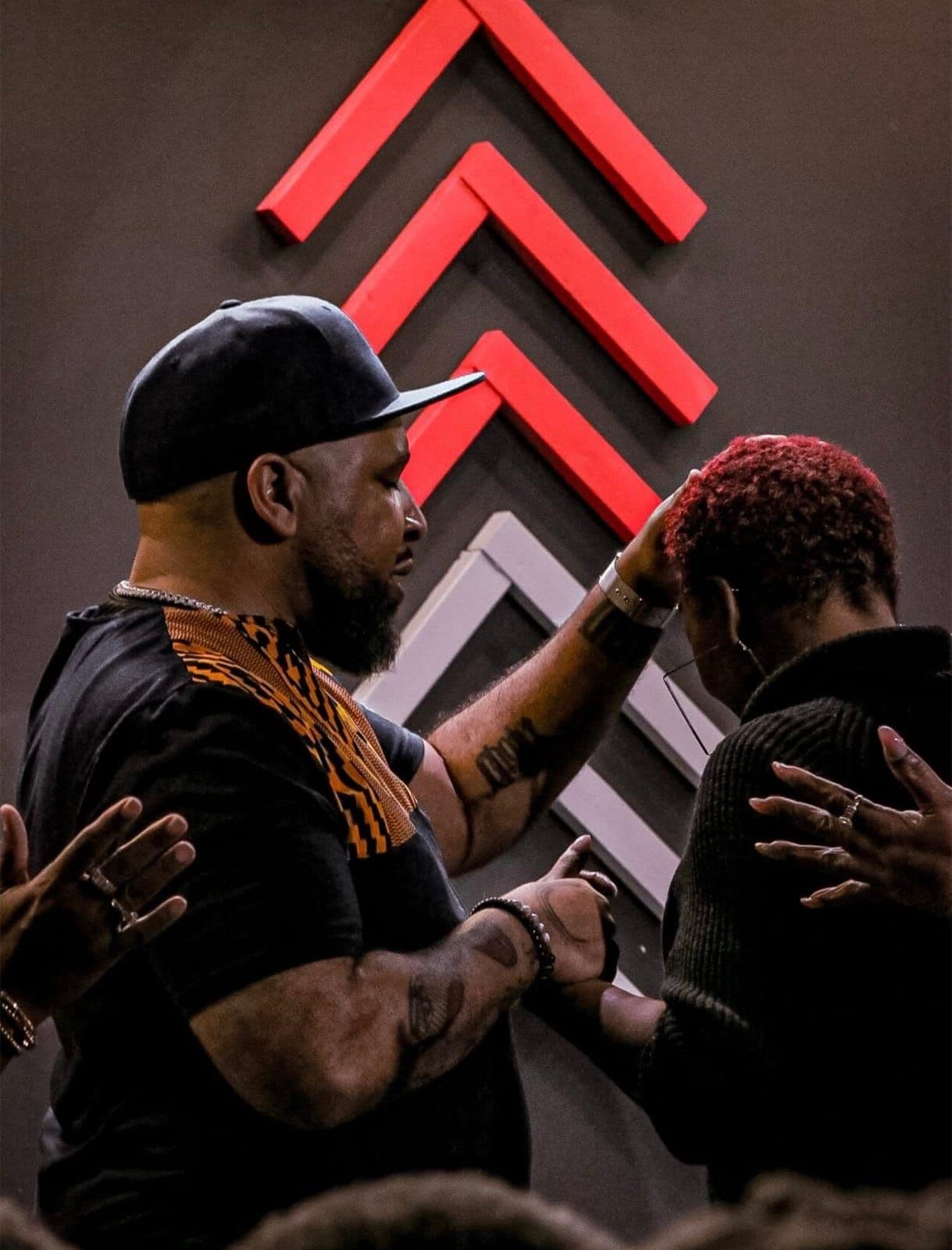 Prayer during a service at Advance Church, with hands laid on a member