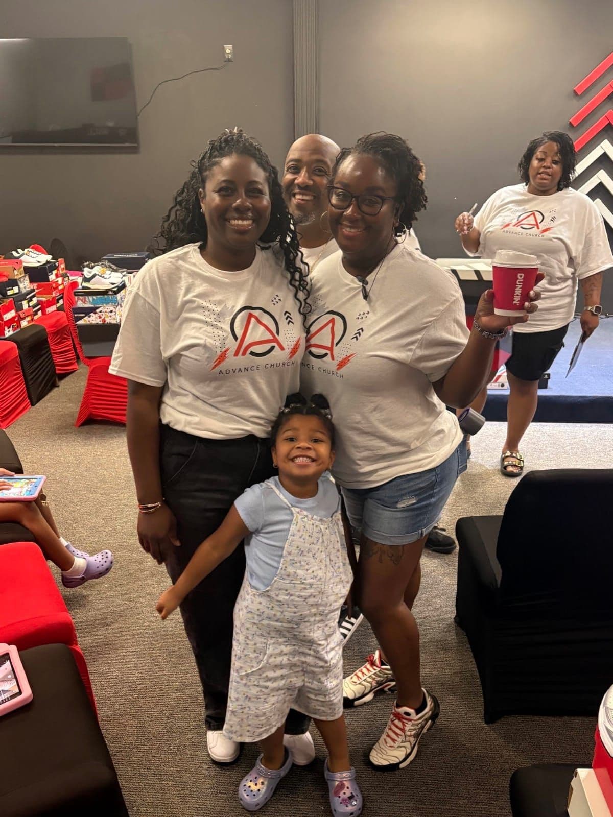 Members of Advance Church and a young girl smiling together at a church gathering